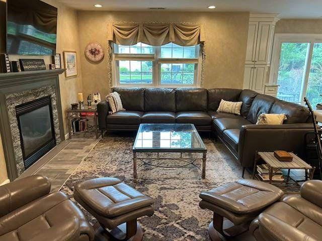 29 Erin Ln Unit 29, East Setauket, NY 11733 - living area with a glass covered fireplace, recessed lighting, and wood finished floors