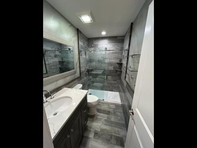 29 Erin Ln Unit 29, East Setauket, NY 11733 - full bathroom featuring vanity and a shower stall