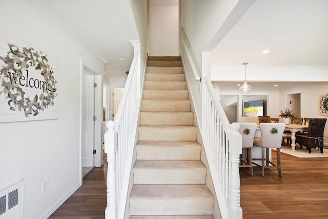 531 Myrtle Ave, West Islip, NY 11795 - stairs with crown molding, wood finished floors, and recessed lighting