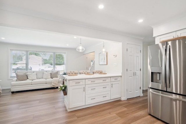 531 Myrtle Ave, West Islip, NY 11795 - kitchen featuring stainless steel fridge with ice dispenser, crown molding, white cabinetry, light wood-type flooring, and light countertops