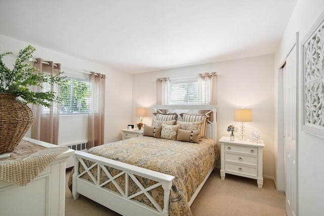 531 Myrtle Ave, West Islip, NY 11795 - bedroom featuring multiple windows, light carpet, a closet, and radiator heating unit