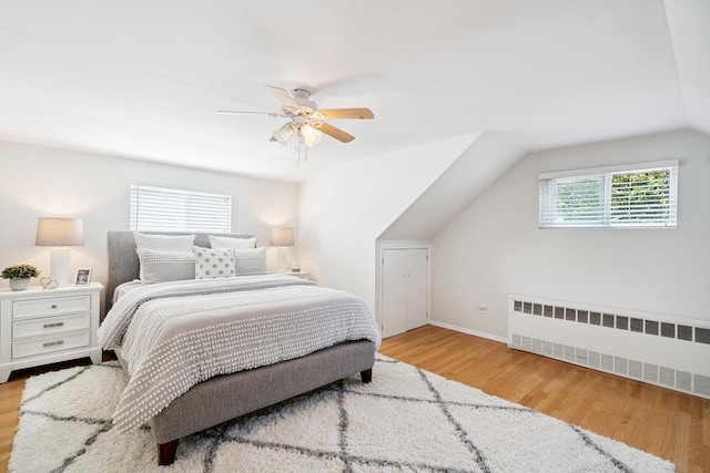 531 Myrtle Ave, West Islip, NY 11795 - bedroom with radiator, vaulted ceiling, wood finished floors, and a ceiling fan