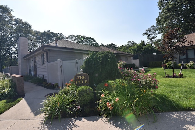 19 Stanford Ct Unit 19, Wantagh, NY 11793 - view of home's exterior featuring a chimney and a gate