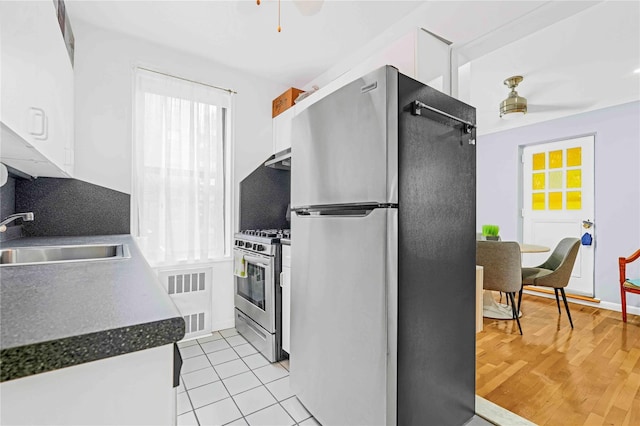 22424 Union Tpke Unit 3C, Oakland Gardens, NY 11364 - kitchen with appliances with stainless steel finishes, a ceiling fan, white cabinets, dark countertops, and tasteful backsplash