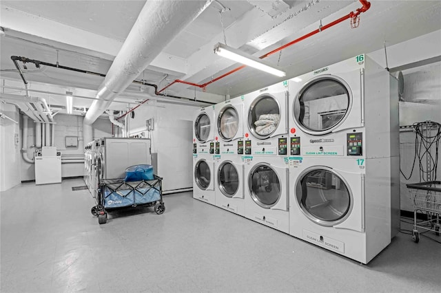 22424 Union Tpke Unit 3C, Oakland Gardens, NY 11364 - communal laundry room with stacked washer and clothes dryer, washer and dryer, and tile patterned floors