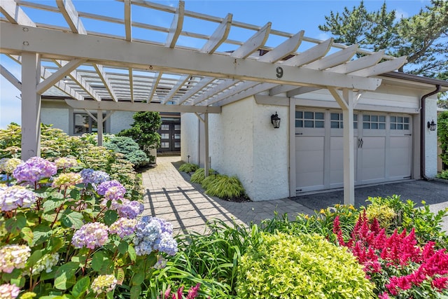 9 Captains Walk E, Bay Shore, NY 11706 - exterior space with a pergola, stucco siding, and an attached garage