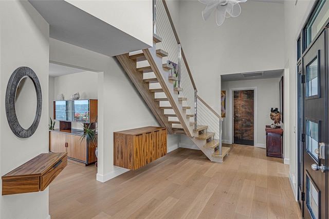 9 Captains Walk E, Bay Shore, NY 11706 - foyer featuring stairs, light wood-type flooring, a high ceiling, and ceiling fan