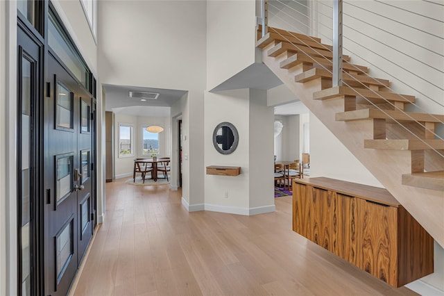 9 Captains Walk E, Bay Shore, NY 11706 - foyer entrance featuring light wood finished floors, a high ceiling, and stairs