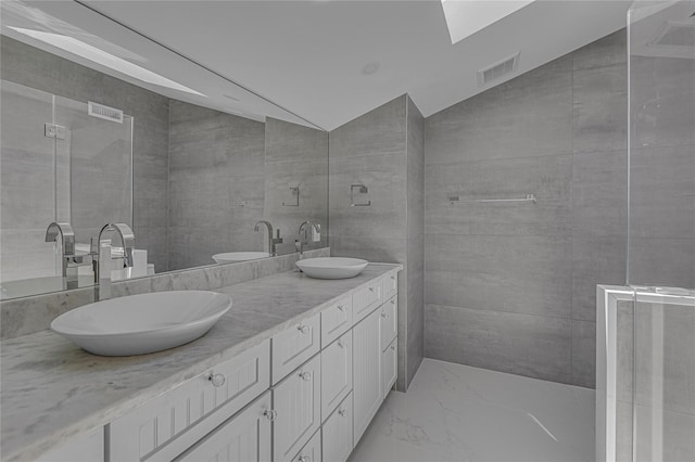 9 Captains Walk E, Bay Shore, NY 11706 - full bathroom with marble look tiles, double vanity, and vaulted ceiling