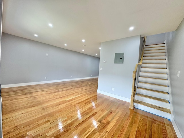 114-62 203rd St, Saint Albans, NY 11412 - unfurnished living room with stairs, electric panel, light wood finished floors, and recessed lighting
