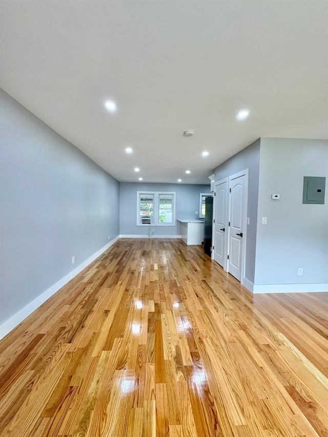 114-62 203rd St, Saint Albans, NY 11412 - unfurnished living room featuring light wood-type flooring, electric panel, and recessed lighting