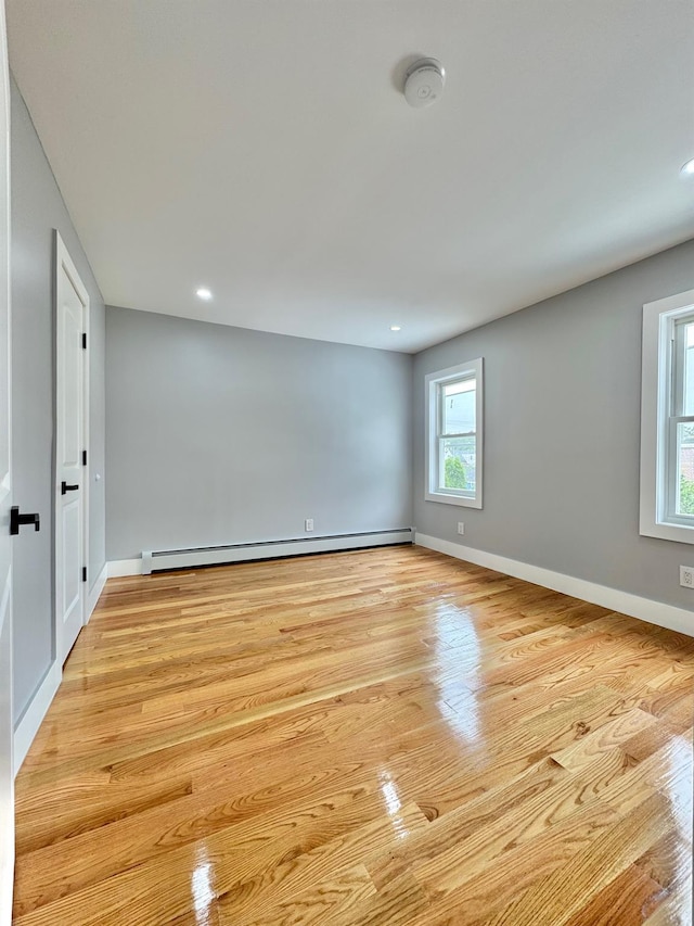 114-62 203rd St, Saint Albans, NY 11412 - empty room featuring baseboard heating, light wood-style floors, a smoke detector, and recessed lighting