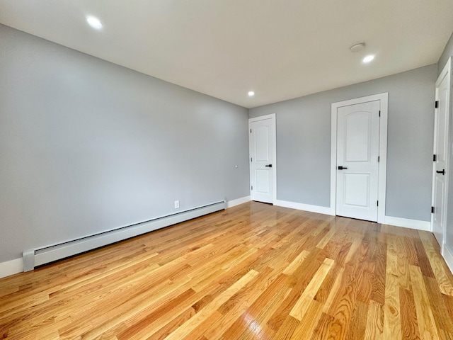 114-62 203rd St, Saint Albans, NY 11412 - unfurnished bedroom with baseboard heating, light wood-type flooring, and recessed lighting