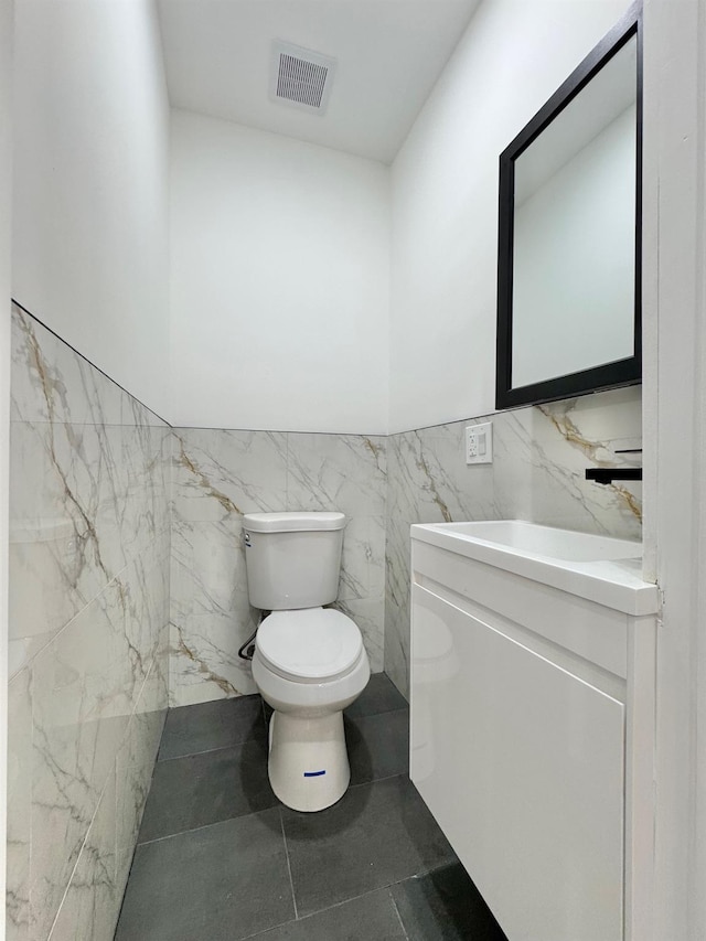 114-62 203rd St, Saint Albans, NY 11412 - half bathroom with vanity, tile walls, and a wainscoted wall