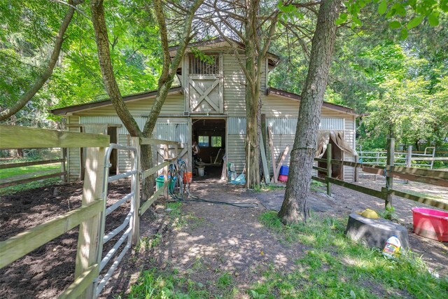 33 N Coleman Rd, Centereach, NY 11720 - back of property featuring an exterior structure and an outbuilding