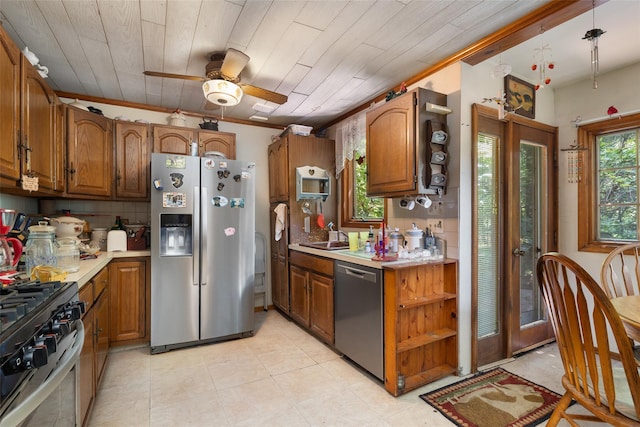 33 N Coleman Rd, Centereach, NY 11720 - kitchen with appliances with stainless steel finishes, brown cabinetry, light countertops, crown molding, and wood ceiling