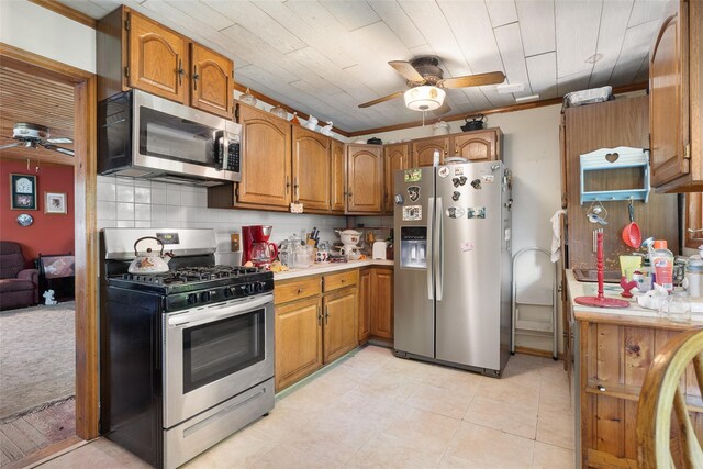 33 N Coleman Rd, Centereach, NY 11720 - kitchen with stainless steel appliances, ceiling fan, brown cabinetry, and light countertops