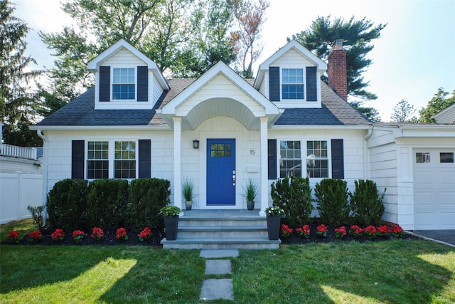 15 Le Britton St, Locust Valley, NY 11560 - view of front of house with a shingled roof, a front lawn, a chimney, and a garage