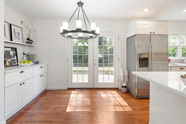 15 Le Britton St, Locust Valley, NY 11560 - kitchen with high end refrigerator, a chandelier, light countertops, decorative light fixtures, and white cabinetry