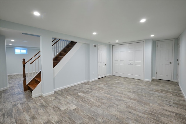 15 Le Britton St, Locust Valley, NY 11560 - below grade area with wood finished floors, recessed lighting, and stairway