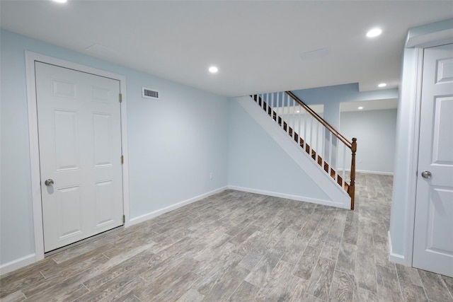 15 Le Britton St, Locust Valley, NY 11560 - empty room featuring light wood-style flooring, stairway, and recessed lighting