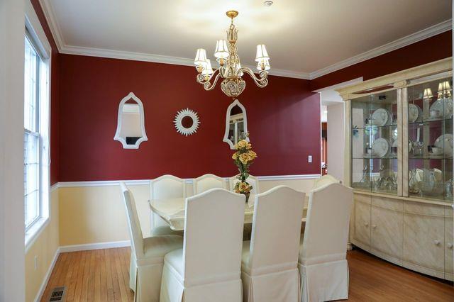 97 Reunion Rd, White Plains, NY 10603 - dining area with a chandelier, wood finished floors, and ornamental molding