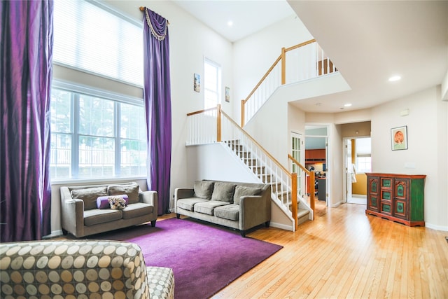 97 Reunion Rd, White Plains, NY 10603 - living room featuring stairs, wood-type flooring, a high ceiling, and recessed lighting