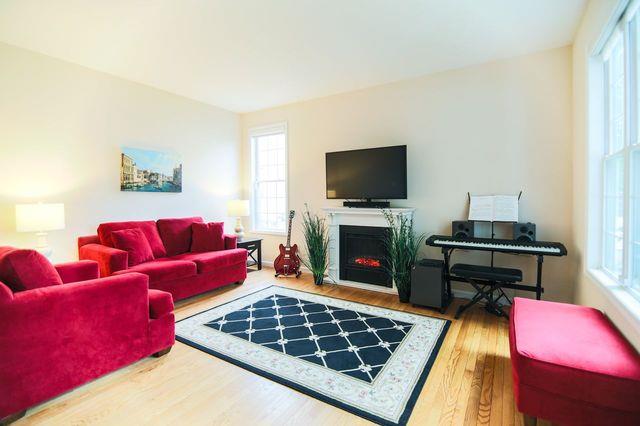 97 Reunion Rd, White Plains, NY 10603 - living area with wood finished floors and a fireplace