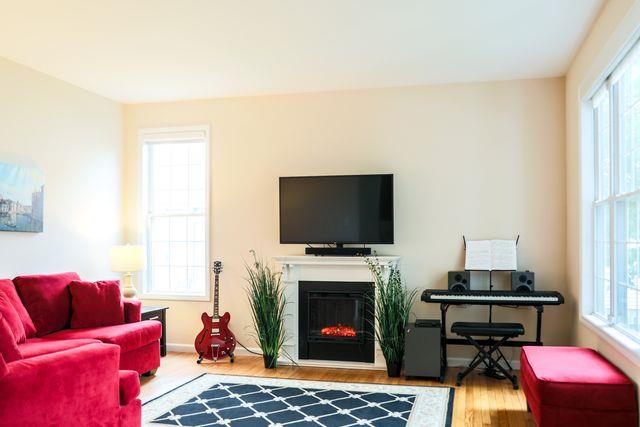 97 Reunion Rd, White Plains, NY 10603 - living room with wood finished floors and a glass covered fireplace
