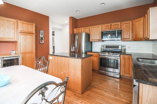 97 Reunion Rd, White Plains, NY 10603 - kitchen with stainless steel appliances, light wood-style flooring, tasteful backsplash, recessed lighting, and dark stone countertops