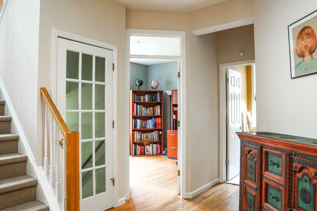 97 Reunion Rd, White Plains, NY 10603 - hall with light wood finished floors and stairs