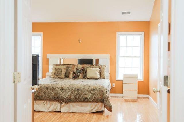 97 Reunion Rd, White Plains, NY 10603 - bedroom with wood finished floors and multiple windows