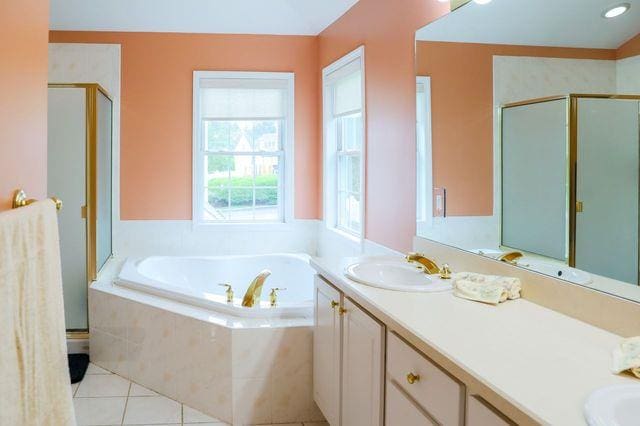 97 Reunion Rd, White Plains, NY 10603 - bathroom featuring double vanity, a stall shower, a bath, and tile patterned floors