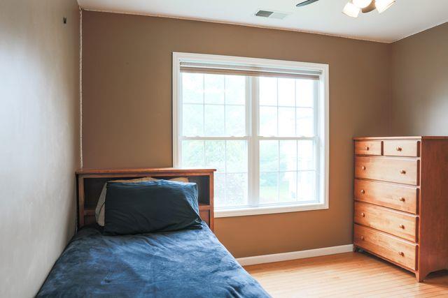 97 Reunion Rd, White Plains, NY 10603 - bedroom with light wood-type flooring and ceiling fan