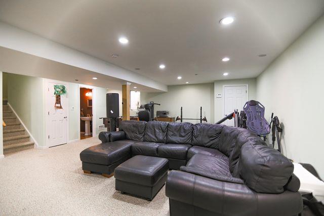 97 Reunion Rd, White Plains, NY 10603 - living area with recessed lighting, stairs, and light colored carpet
