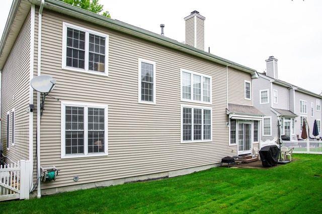 97 Reunion Rd, White Plains, NY 10603 - back of property with a chimney and entry steps