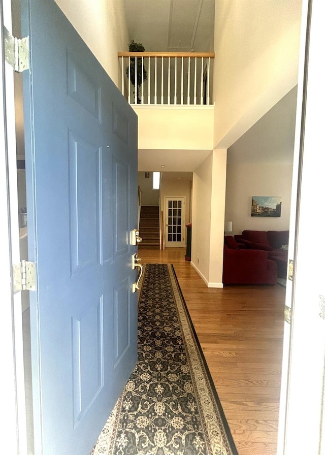 97 Reunion Rd, White Plains, NY 10603 - foyer featuring wood finished floors, a high ceiling, and stairway