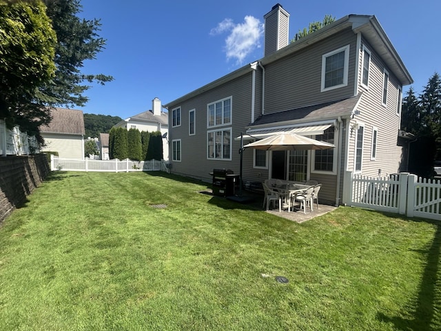 97 Reunion Rd, White Plains, NY 10603 - rear view of property featuring a chimney, a patio, and a fenced backyard