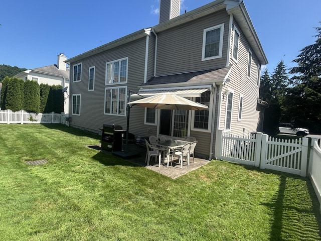 97 Reunion Rd, White Plains, NY 10603 - back of house featuring a fenced backyard, a chimney, and a patio area