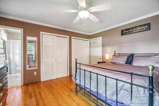 30 Lincoln Ave, Port Jefferson Station, NY 11776 - bedroom featuring two closets, wood finished floors, crown molding, ensuite bath, and ceiling fan