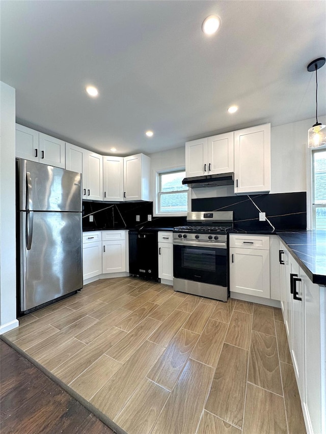 37 E Fulton St, Lido Beach, NY 11561 - kitchen featuring stainless steel appliances, under cabinet range hood, dark countertops, plenty of natural light, and recessed lighting