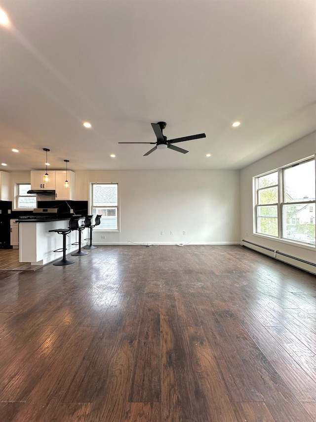 37 E Fulton St, Lido Beach, NY 11561 - unfurnished living room featuring healthy amount of natural light, recessed lighting, dark wood-type flooring, baseboard heating, and ceiling fan