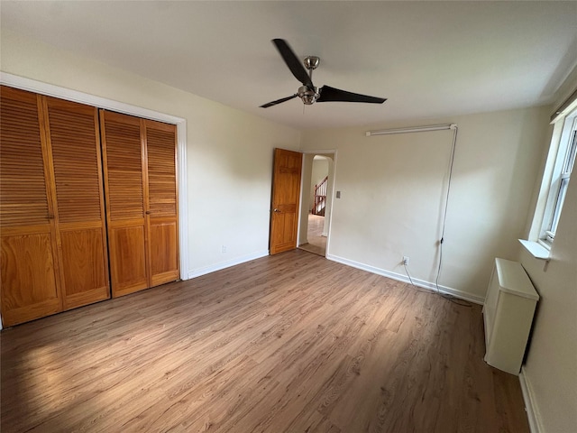 255-31 75th Ave Fl 2Nd, Glen Oaks, NY 11004 - unfurnished bedroom with light wood-style flooring, a closet, and a ceiling fan