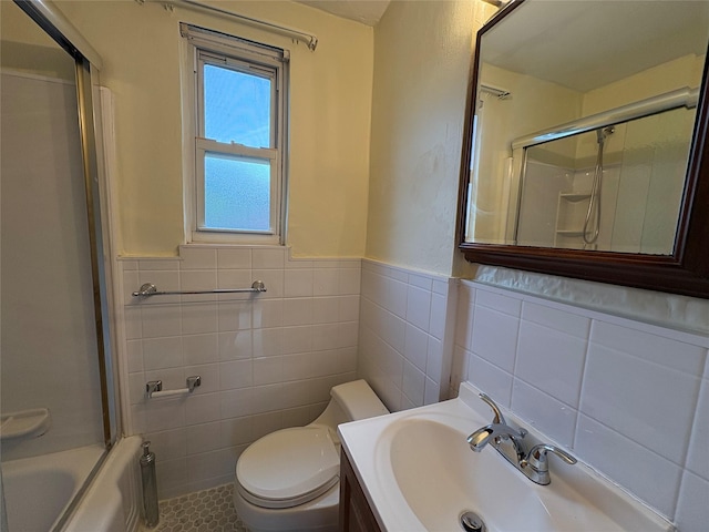 255-31 75th Ave Fl 2Nd, Glen Oaks, NY 11004 - bathroom featuring tile walls, vanity, a wainscoted wall, tile patterned flooring, and enclosed tub / shower combo