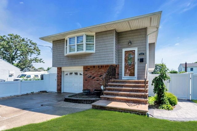 544 S 15th St, Lindenhurst, NY 11757 - split level home with driveway, an attached garage, and brick siding