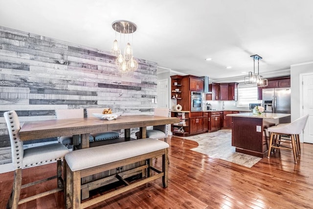 544 S 15th St, Lindenhurst, NY 11757 - dining area featuring a chandelier, light wood-type flooring, recessed lighting, and crown molding