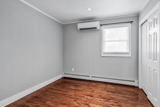 544 S 15th St, Lindenhurst, NY 11757 - unfurnished bedroom featuring a wall mounted air conditioner, a baseboard heating unit, ornamental molding, wood finished floors, and a closet