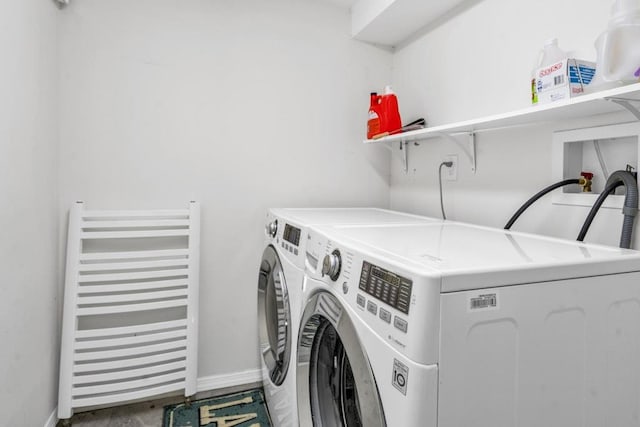 544 S 15th St, Lindenhurst, NY 11757 - laundry room with radiator heating unit and washing machine and dryer