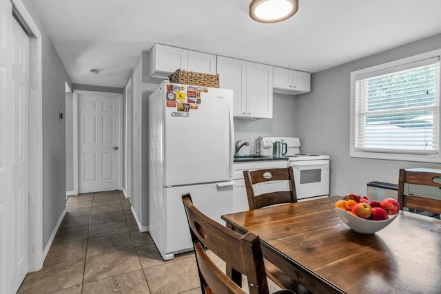 544 S 15th St, Lindenhurst, NY 11757 - kitchen with white appliances, light tile patterned floors, and white cabinets