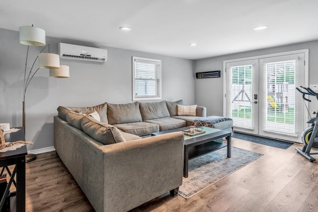 544 S 15th St, Lindenhurst, NY 11757 - living room with a wall unit AC, french doors, wood finished floors, and recessed lighting